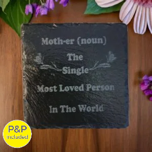 Engraved slate plaque with the definition of mother reading “The single most loved person in the world”, decorative flowers around the plaque.