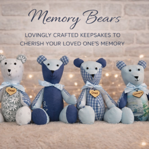 Group of memory bears created from sentimental clothing, featuring a range of fabric designs with a wooden heart tag engraved “Dad”.