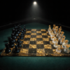 Resin and gold leaf chess set illuminated by a single spotlight on a green gaming table