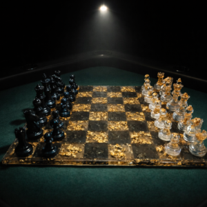 Resin and gold leaf chess set illuminated by a single spotlight on a green gaming table