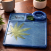 Personalised Blue Resin Herb Tray in Botanical Lifestyle Setting Personalised blue resin herb tray with botanical leaf design and accessories styled on a wooden table in natural light