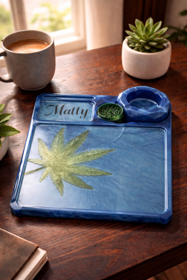 Personalised Blue Resin Herb Tray in Botanical Lifestyle Setting Personalised blue resin herb tray with botanical leaf design and accessories styled on a wooden table in natural light