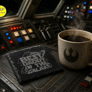 Engraved slate coaster reading Best Daddy in the Galaxy next to a steaming coffee on a sci-fi control panel